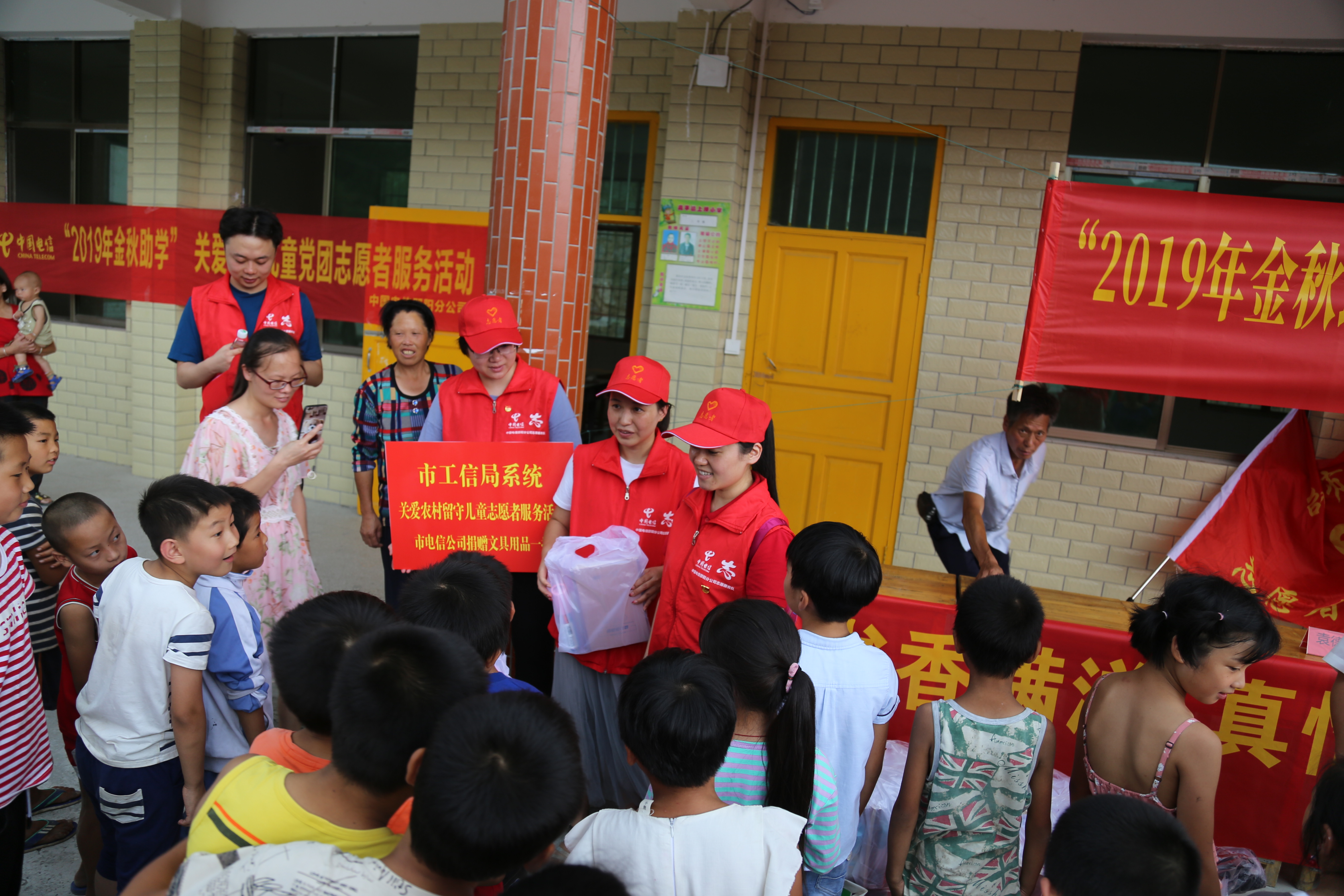 中国电信邵阳分公司志愿者为学生发放学习用品.jpg