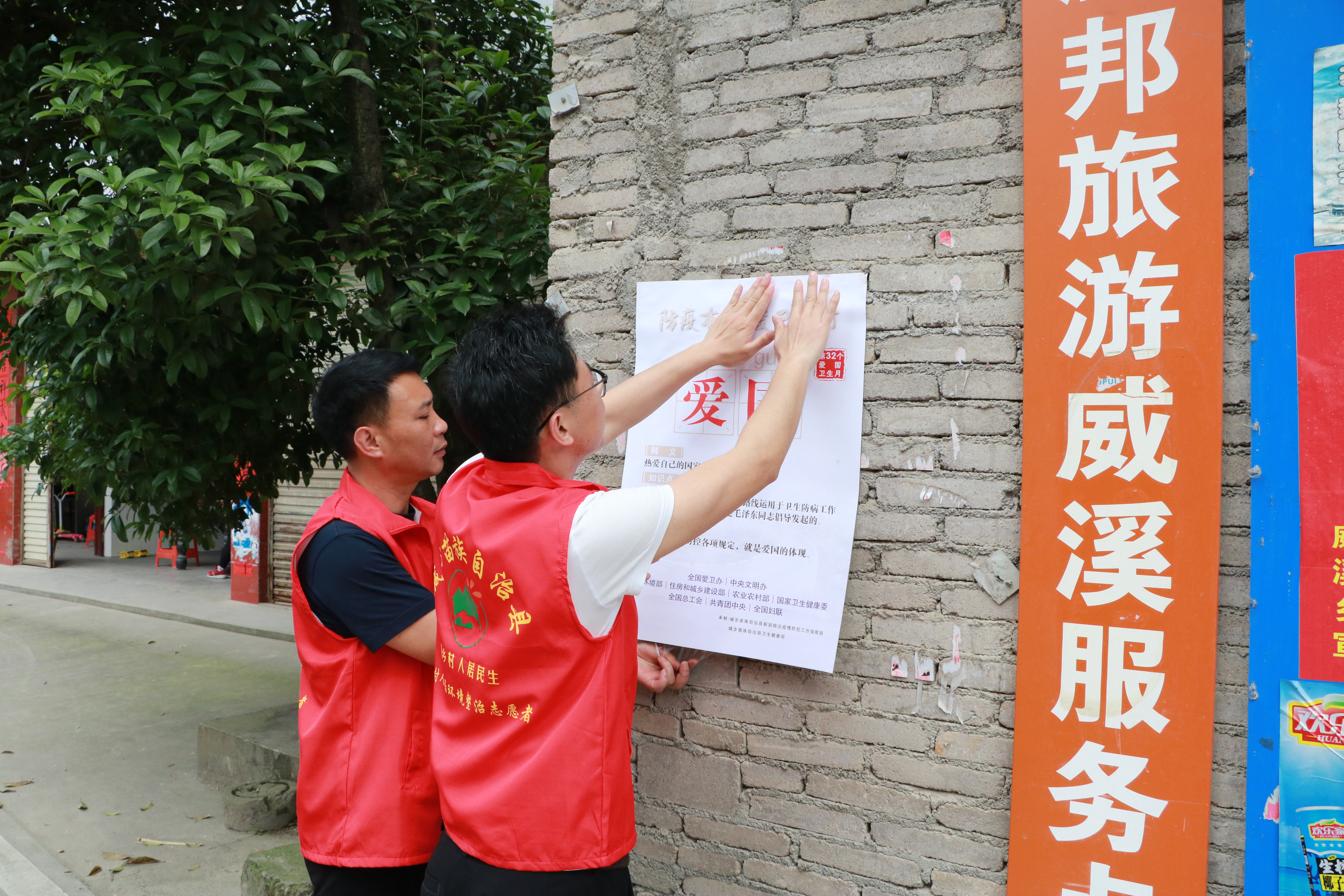 “红马甲”志愿者张贴爱国卫生运动海报.jpg